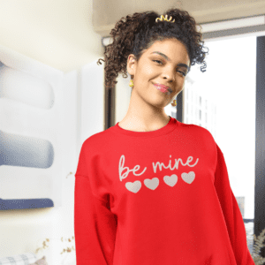 Red Be Mine Sweatshirt with a cozy and stylish design, perfect for expressing love and warmth. The text 'Be Mine' is prominently featured on the front, adding a romantic touch to the garment.