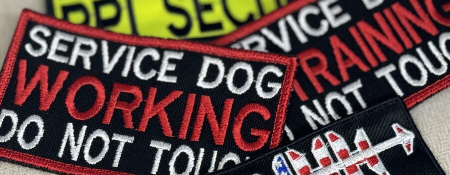 A variety of colorful embroidered patches, including hat patches, service dog patches, and name tags, showcasing the intricate designs and high-quality craftsmanship of Beach Bum Custom Apparel.